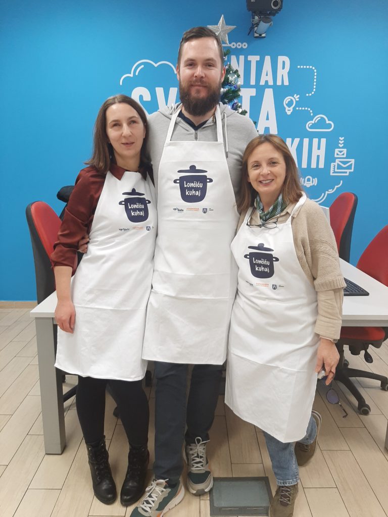 chefs and project manager in aprons with the project logo